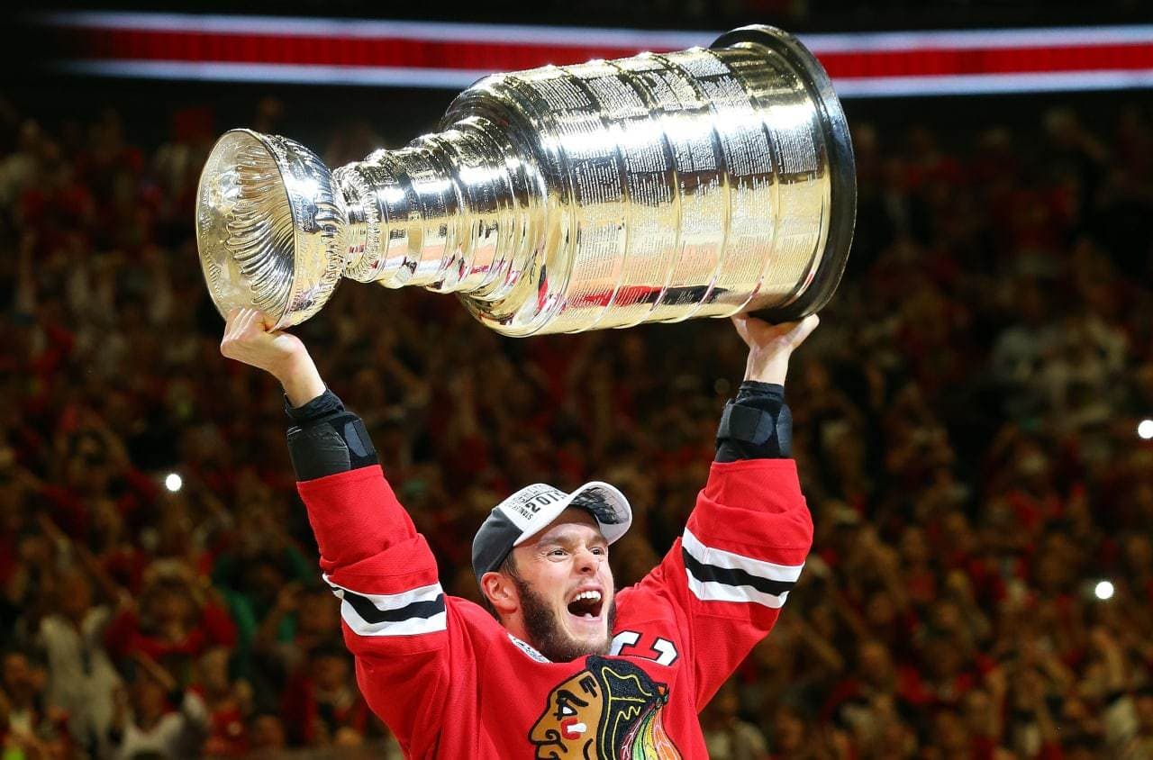 CHICAGO, IL - JUNE 15:  Jonathan Toews #19 of the Chicago Blackhawks celebrates by hoisting the Stanley Cup after defeating the Tampa Bay Lightning  by a score of 2-0 in Game Six to win the 2015 NHL Stanley Cup Final at the United Center  on June 15, 2015 in Chicago, Illinois.  (Photo by Bruce Bennett/Getty Images)