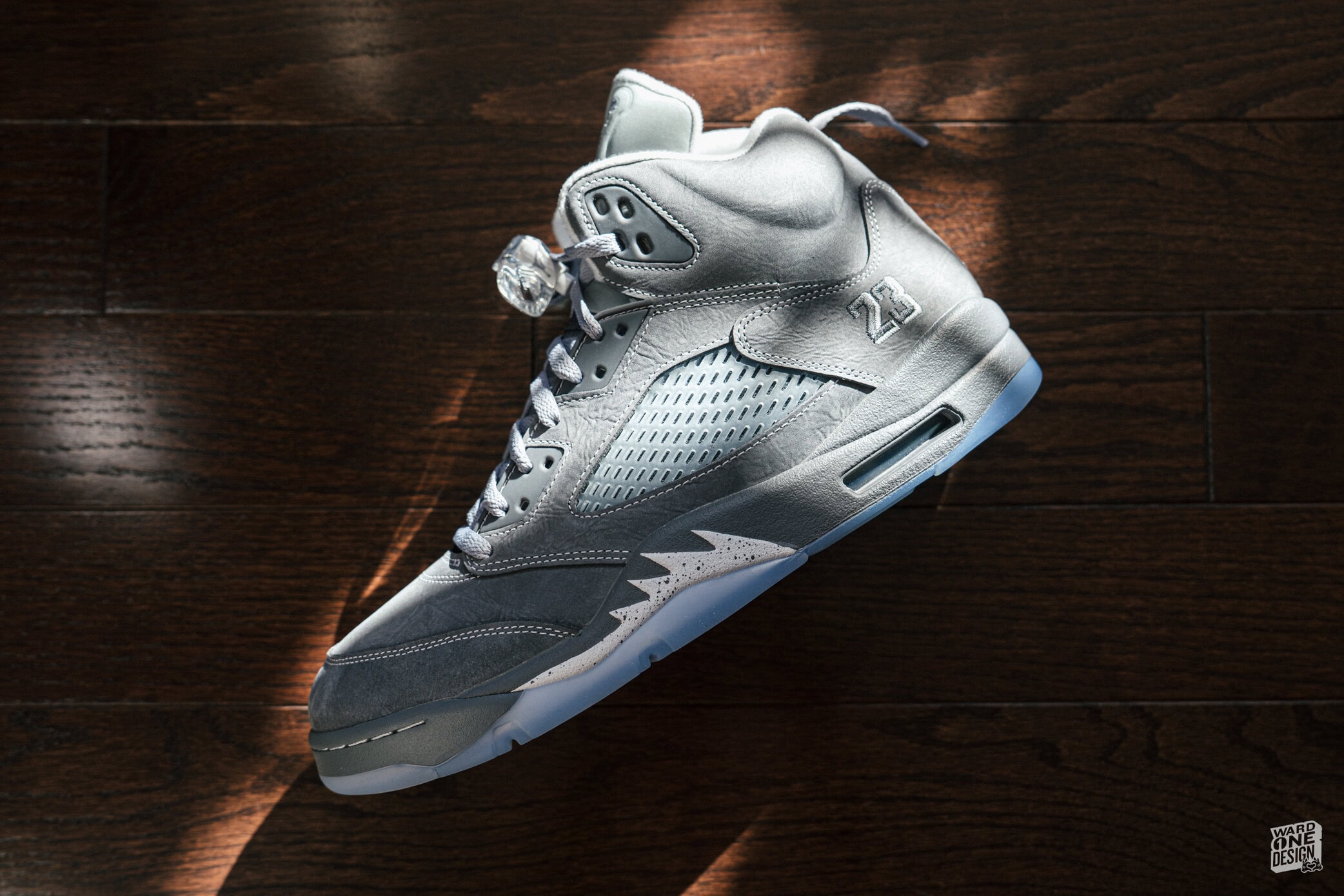 Close-up of Air Jordan 5 Wolf Grey sneakers showcasing premium materials and sleek design, perfect for sneaker enthusiasts and collectors.
