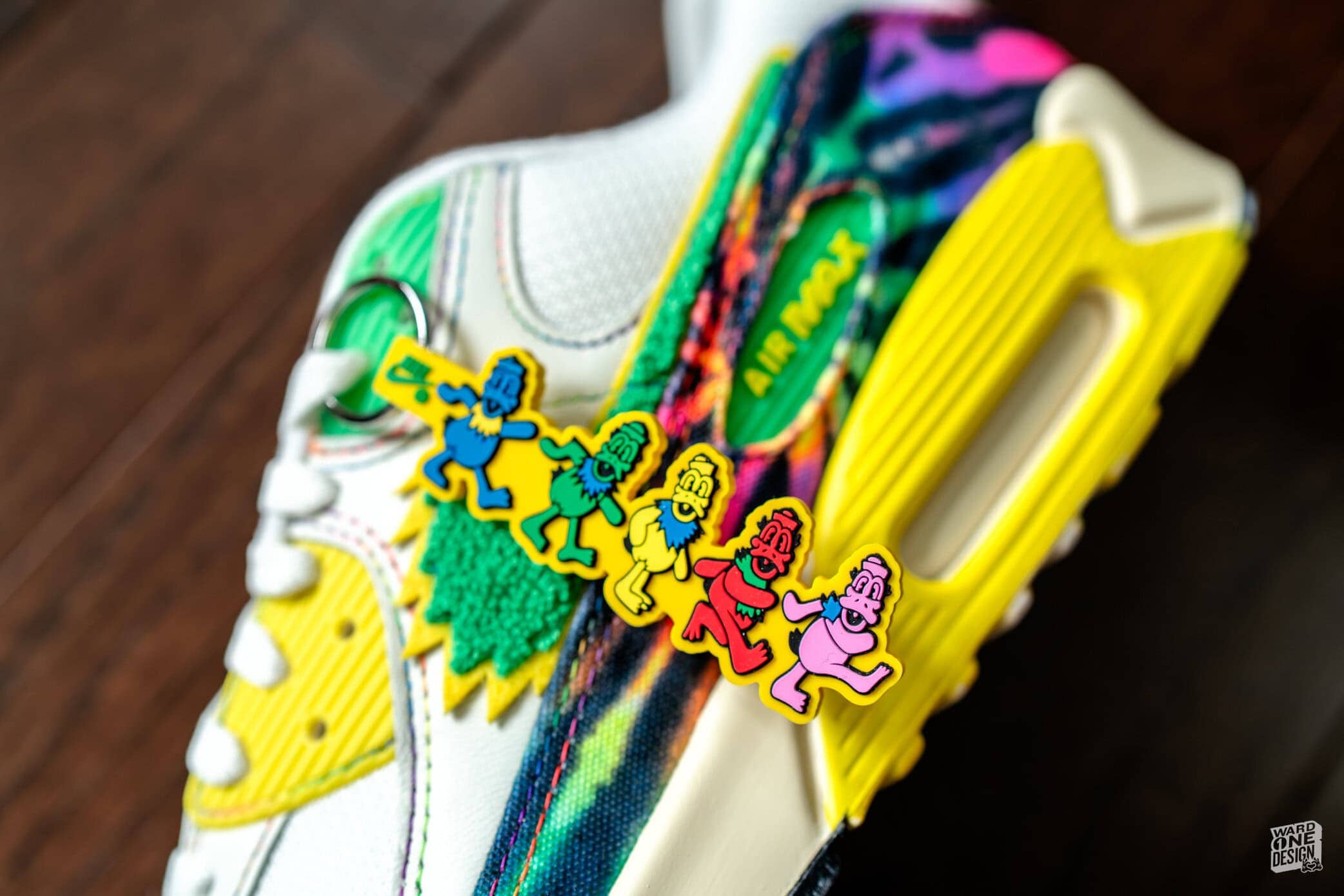 Colorful Custom Sneakers with Fun Charms Vibrant custom sneakers featuring colorful charms and a multicolored design, perfect for casual wear and expressing personal style.