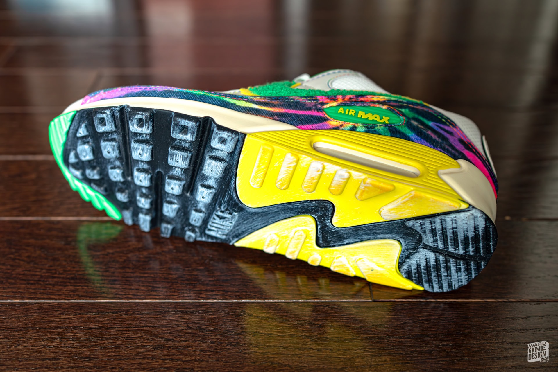 Colorful Nike Air Max 90 sneaker featuring vibrant pink, green, yellow, and purple accents with a durable rubber sole, perfect for sneaker enthusiasts and collectors.