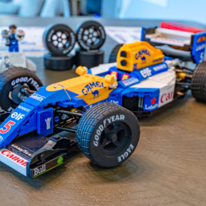 Detailed Lego Williams FW14B model from the Williams Racing team, featuring iconic blue and yellow livery, large tires, and detailed aerodynamic components.
