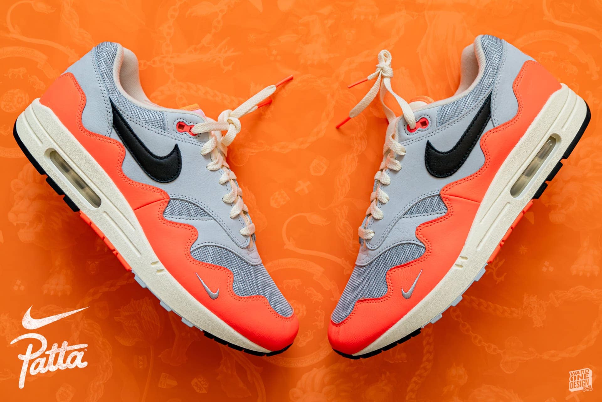 Nike Air Max Sneakers for Men and Women Pair of Nike Air Max sneakers in gray, orange, and black on an orange background, showcasing stylish athletic footwear.