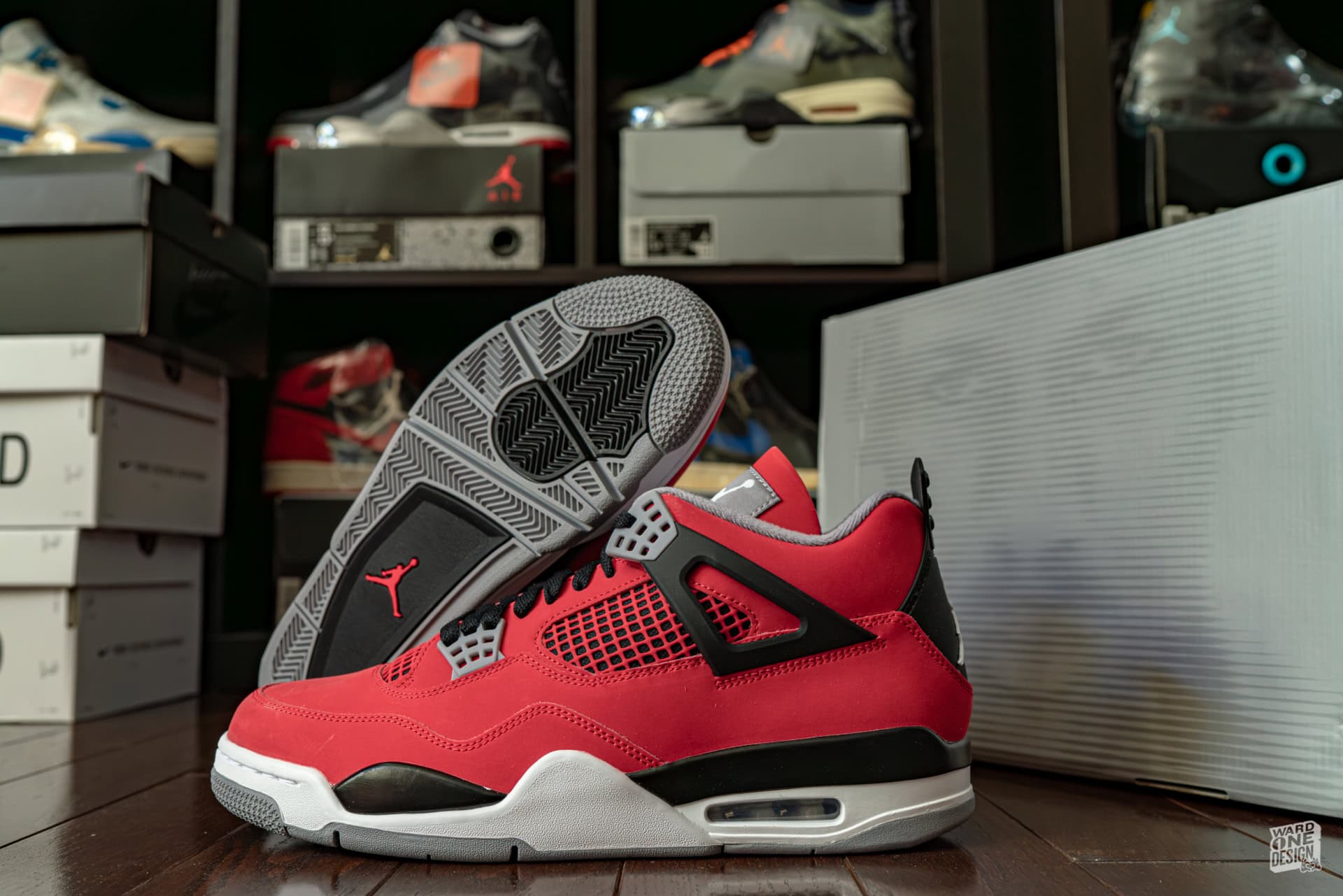 Air Jordan retro sneakers displayed on the floor of a sneaker store, with multiple shoe boxes and other athletic shoes in the background.