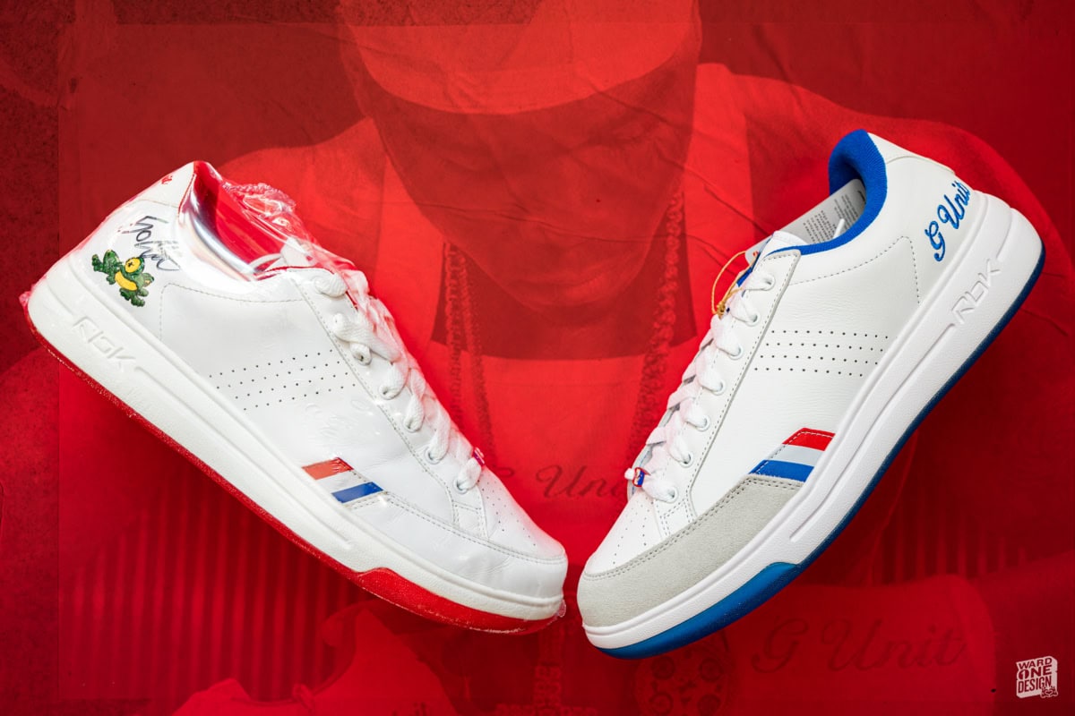 Pair of Reebok G-Unit G6 sneakers with white base, red and blue accents, showcased on a red background for promotional display.