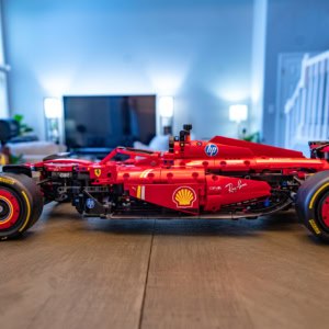Lego model of the Ferrari SF-24 F1 race car, detailed and realistic, showcasing the iconic red design with sponsor logos like Shell and HP. Perfect for F1 fans and Lego enthusiasts.