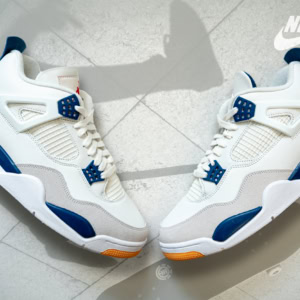 White Nike SB x Air Jordan 4 sneakers with blue accents, showcasing a stylish collaboration for skateboarding and basketball enthusiasts.