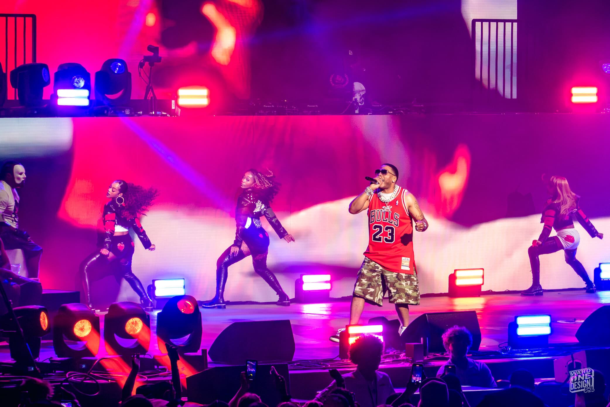 Nelly performing live on stage during the "Where the Party at Tour" with backup dancers and vibrant lighting effects.