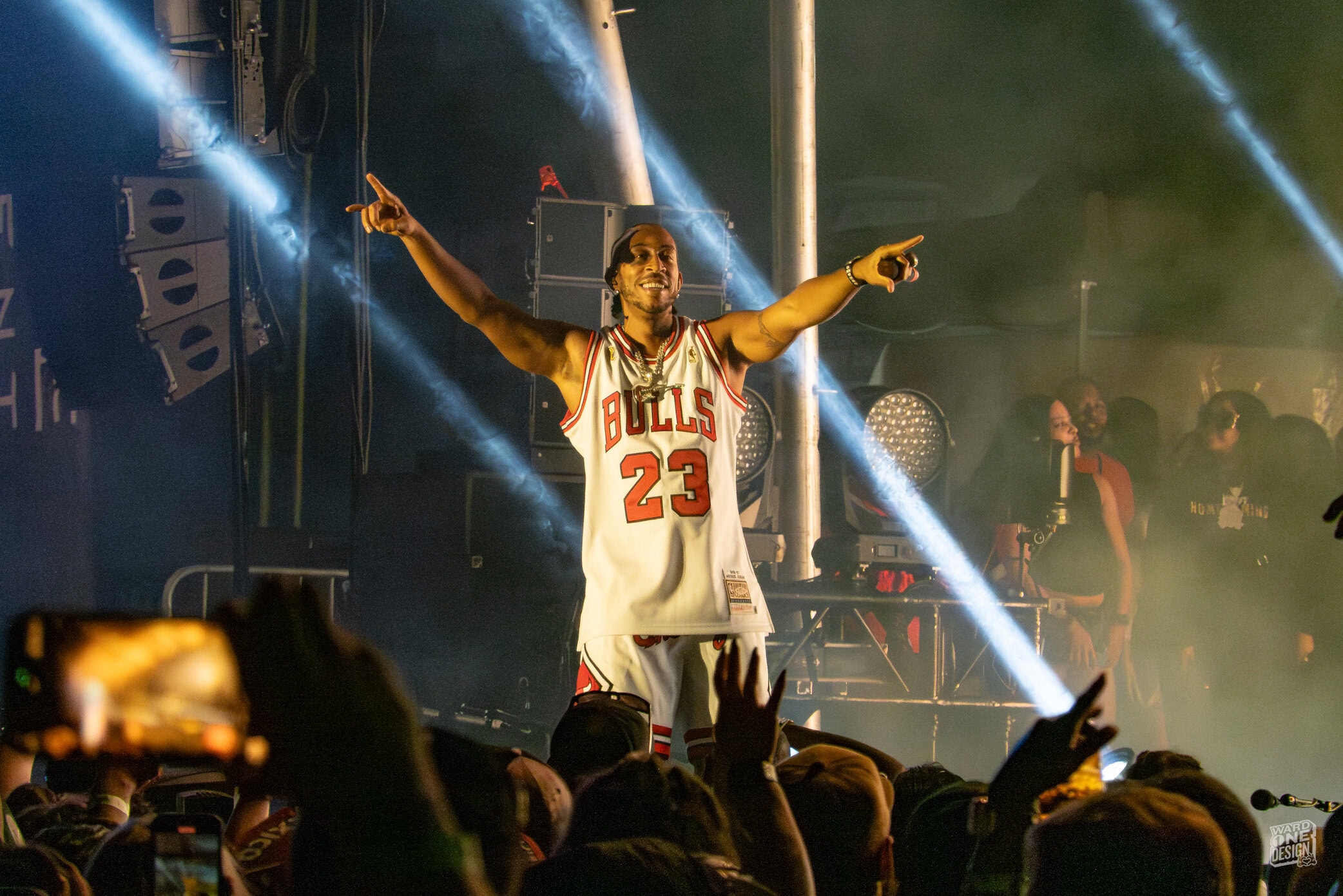 Live performance at Tacos and Tequila in Chicago featuring a rapper in a Chicago Bulls jersey on stage.