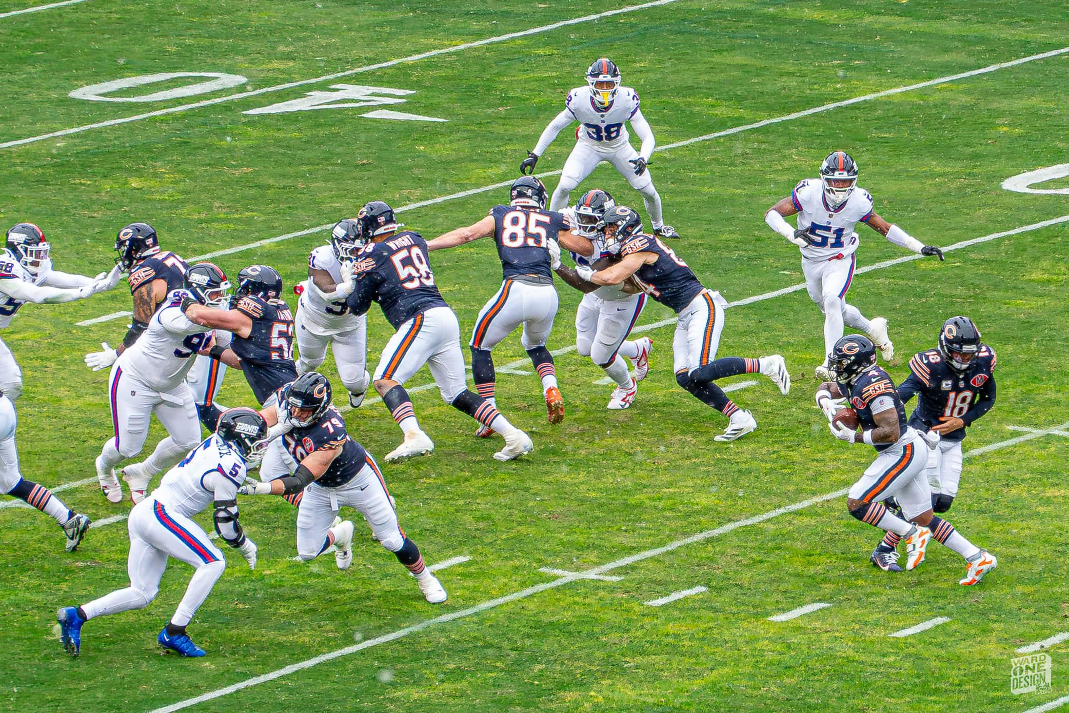 Action shot of Bears and Giants players during an intense NFL game on a green field.