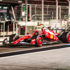 An F1 race car on the pit lane during the 2025 Las Vegas Grand Prix, showcasing high-speed racing technology and vibrant team colors.